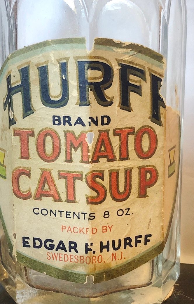 A worn paper label on a glass bottle: Hurff Brand Tomato Catsup, contents 8 oz., packed by Edgar F. Hurff, Swedesboro, N.J.