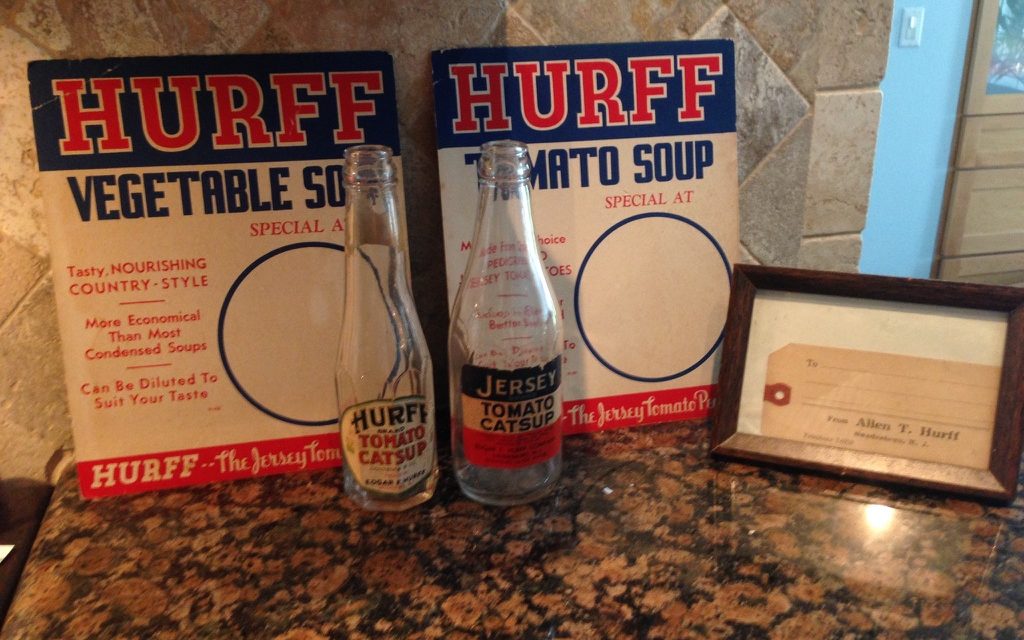 Two Hurff store signs, for Vegetable Soup and Tomato Soup, behind two small catsup bottles labeled Hurff Brand and Jersey Brand, beside a framed shipping tag printed From Allen T. Hurff, Swedesboro, N. J.