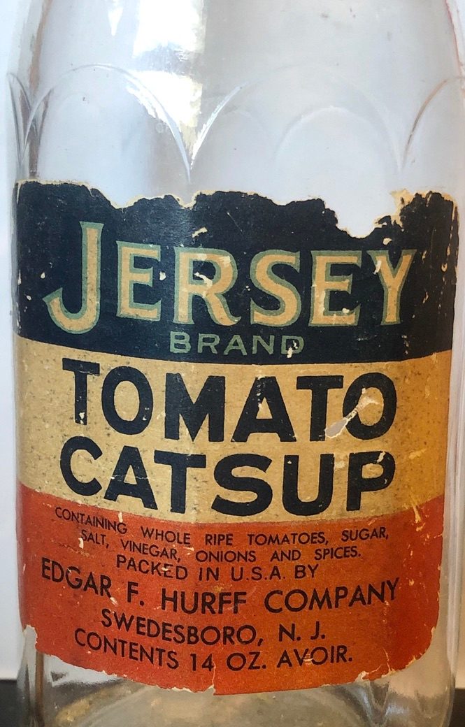 A torn label in blue, cream and red on a glass bottle: Jersey Brand Tomato Catsup, packed in U.S.A. by Edgar F. Hurff Company, Swedesboro, N.J., contents 14 oz.